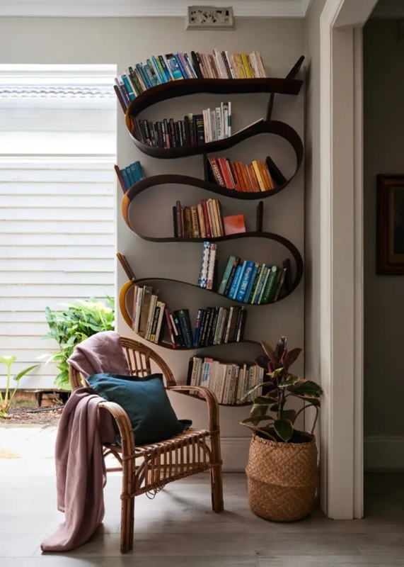 Sculptural Wall Bookshelf with Ribbon Design and Rattan Chair