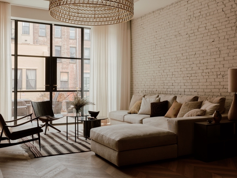 Sectional Sofa In White Brick Wall Living Room With Chevron Wood Floor