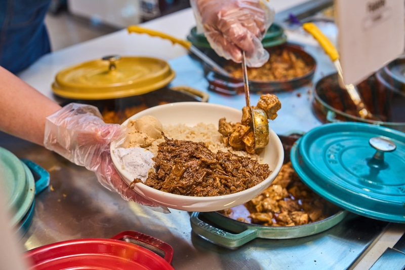 Serving Bowl Closeup: Professional Kitchen with Colorful Dutch Ovens