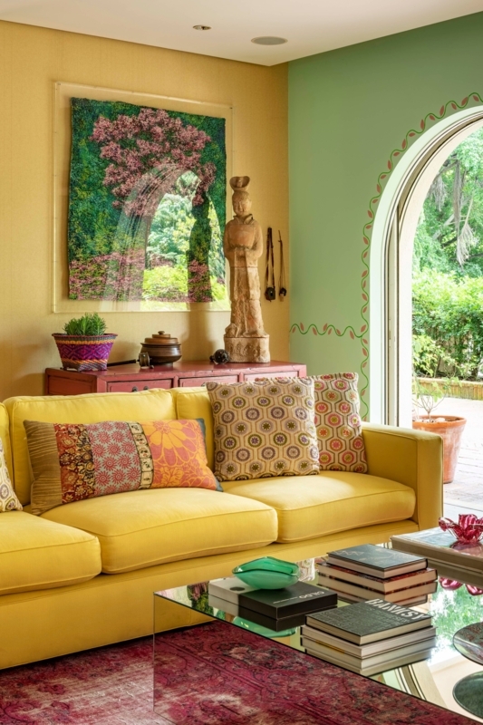Sofa: Sunny Yellow Styling in Maximalist Room with Mirrored Coffee Table