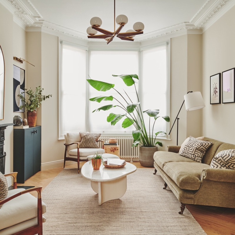 Soft Minimalism Living Room with Sage Green Sofa & Curved Coffee Table.