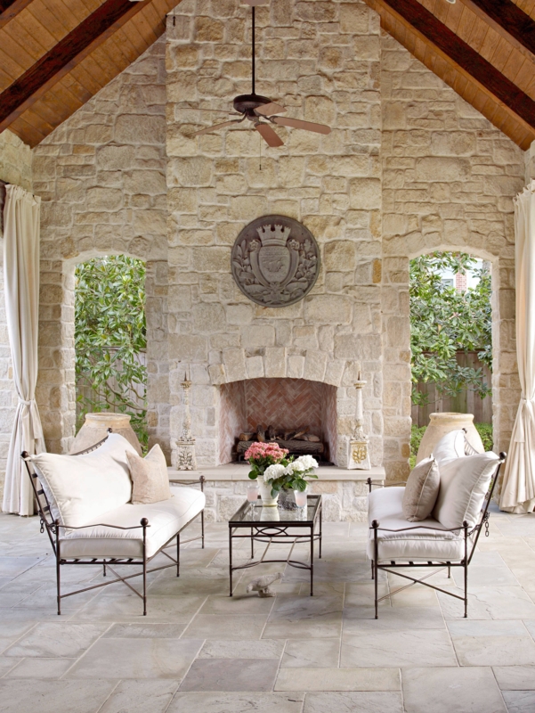 Sophisticated French Country Patio with Grand Stone Fireplace