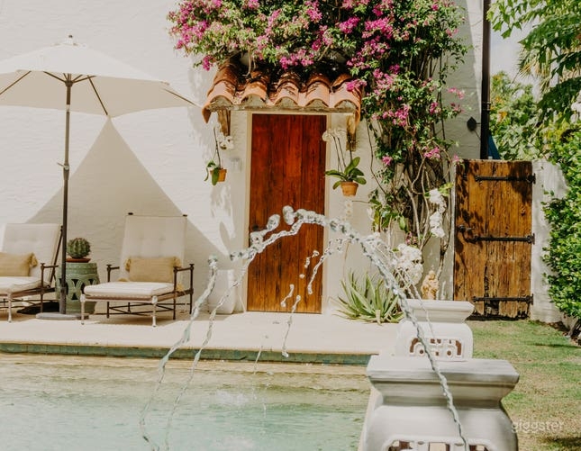 Spanish Style Patio Arcing Fountain Water Magenta Bougainvillea