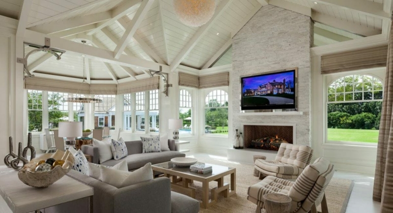 Stone Clad Fireplace in Coastal Living Room with Vaulted Beamed Ceiling