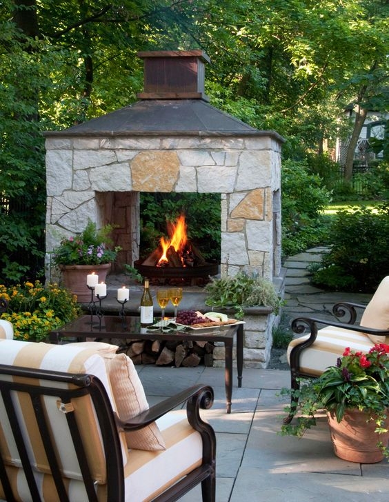 Striped Patio Armchairs near Outdoor Stone Fireplace