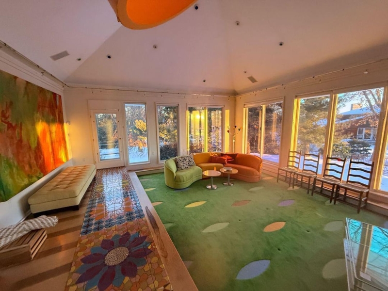 Sunroom: Floral Tile Floor Runner, Curved Multi-Colored Sofa, Leaf Rug
