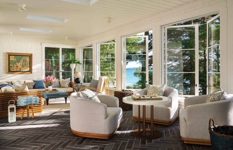 Sunroom Seating Layout with Herringbone Floor and Lake View