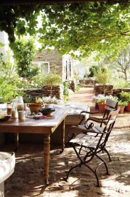 Terrace Dining Area With Stacked Stone Wall & Vine Pergola