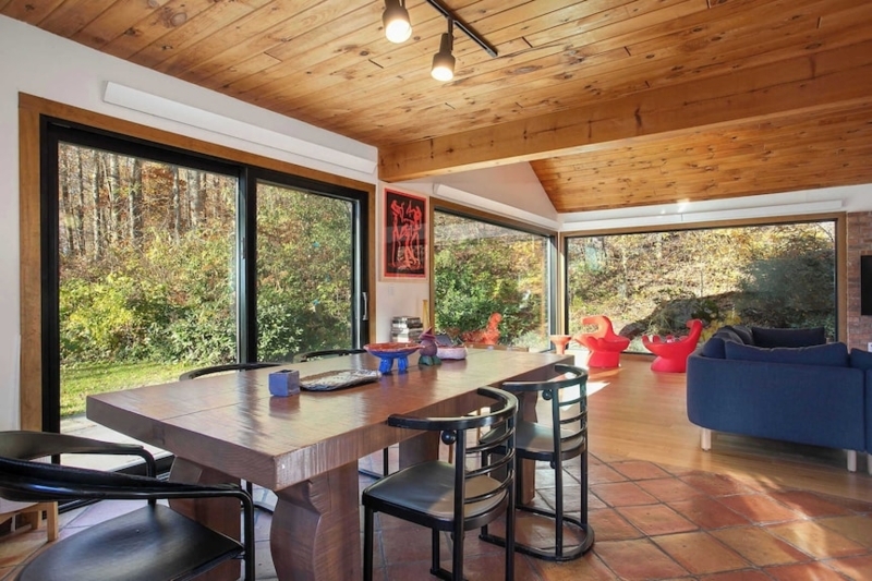 Terracotta Flooring in Open Concept Dining Room with Wraparound Windows