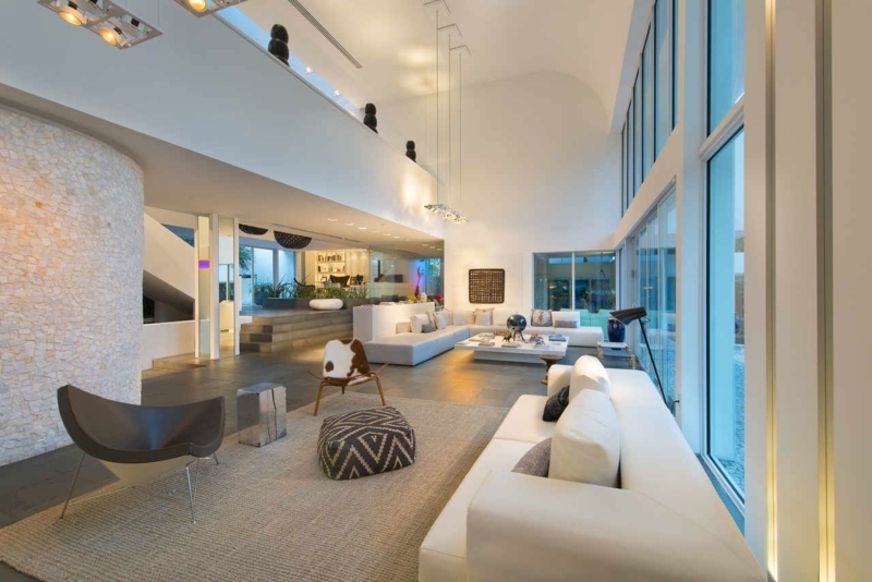 Textured Curved Stone Wall and Mezzanine in Modern Living Room