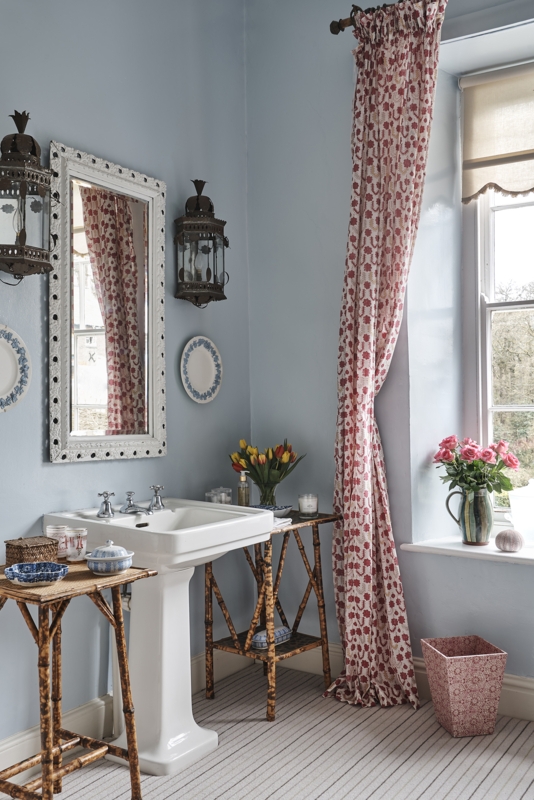 Traditional Bathroom with Bamboo Accent Tables, Pedestal Sink and Floral Curtains