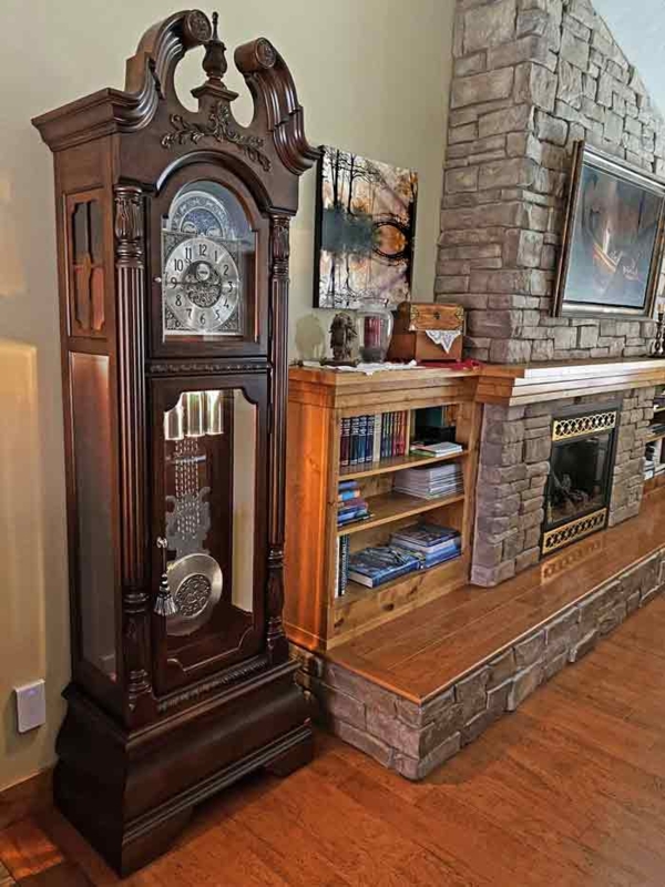 Traditional Dark Wood Grandfather Clock by Stone Fireplace