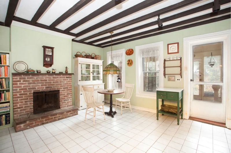 Traditional Dining Room With Fireplace And Exposed Wood Beams