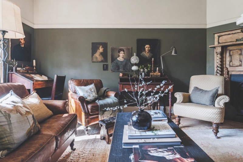 Traditional English Living Room with Dark Green Walls & Portrait Gallery