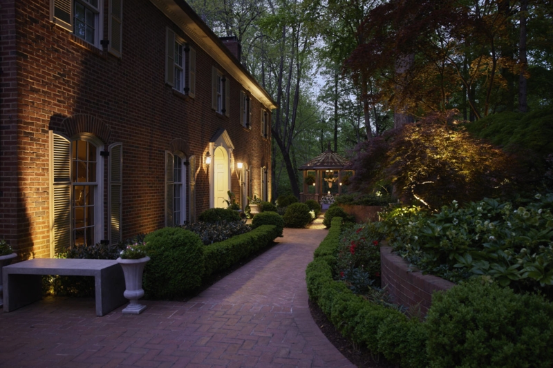 Traditional Garden with Manicured Hedges and Herringbone Brick Path