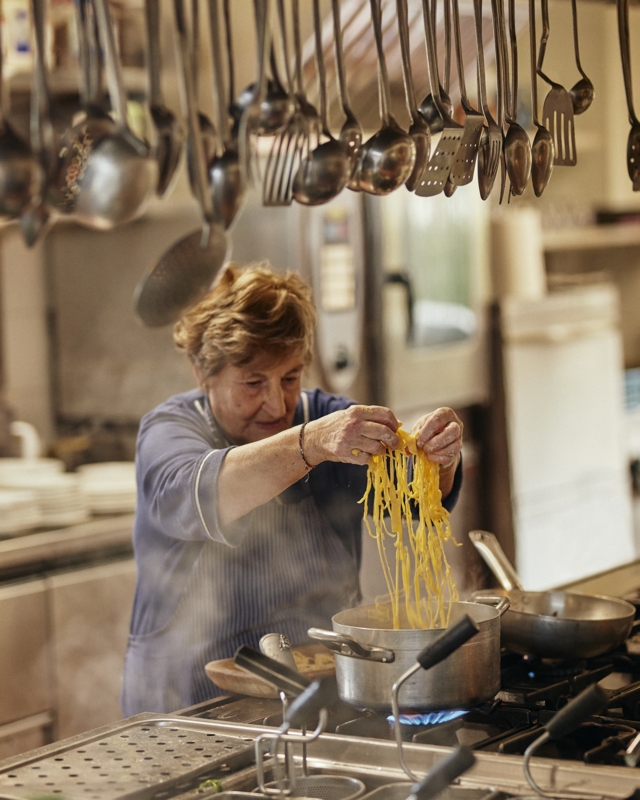 Traditional Italian Kitchen Scene with Dense Overhead Utensil Collection