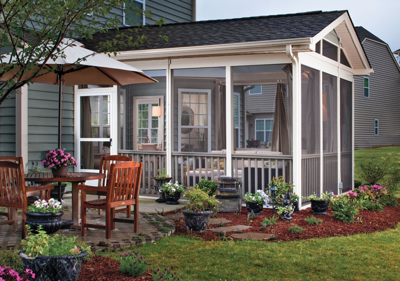 Traditional Porch with Attached Patio, Wooden Dining Set & Curtains.
