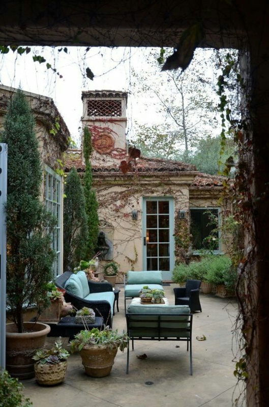 Tranquil French Country Patio Seating with Lush Climbing Vines
