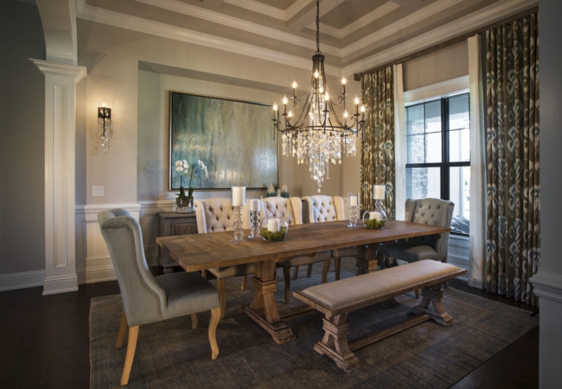 Transitional Dining Room with wood trestle table and coffered ceiling.