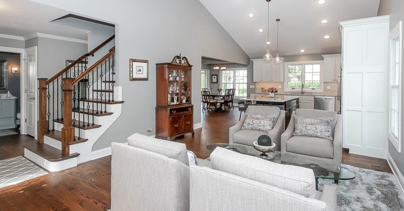 Transitional Living Room: Grey Palette, Vaulted Ceiling & Iron Balusters