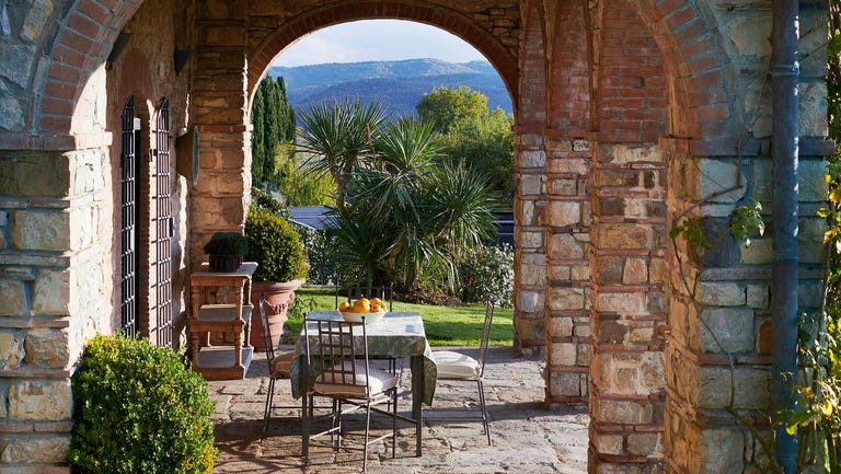 Tuscan Patio Dining: Exposed Brick Arches & Panoramic View