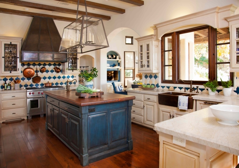 Tuscan Style Kitchen with Blue Island, Wood Beams, and Quatrefoil Tile
