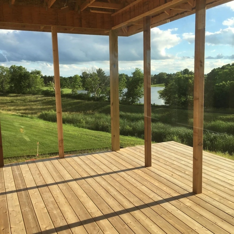 Unfinished Screened Porch with Wood Decking and Scenic Lake View.