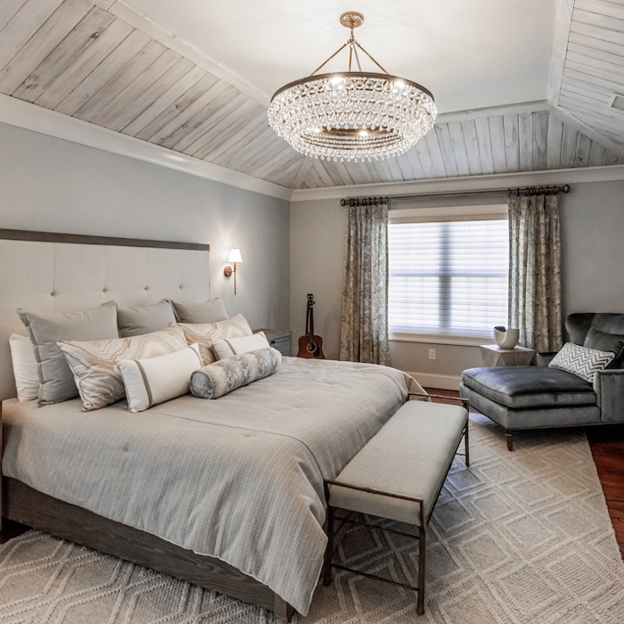 Upholstered Bed in Vaulted Wood Ceiling Bedroom with Geometric Rug