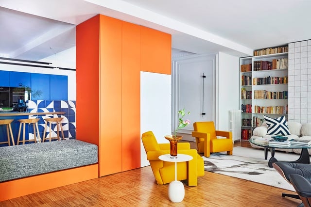 Vibrant Color Blocked Living Room featuring an Orange Partition Wall