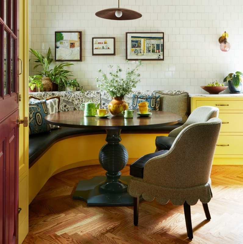 Vibrant Dining Nook with Scalloped Chair Skirts and Yellow Banquette