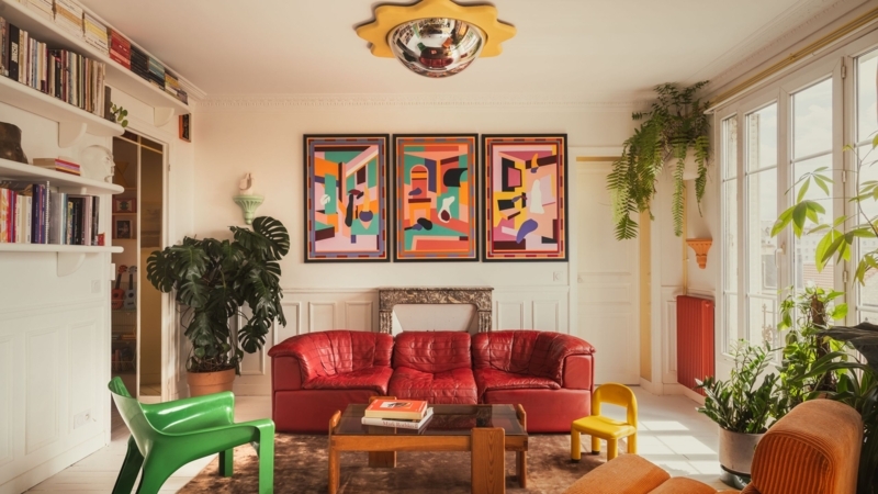 Vibrant Red Leather Sofa Styling with Sun Shaped Ceiling Mirror
