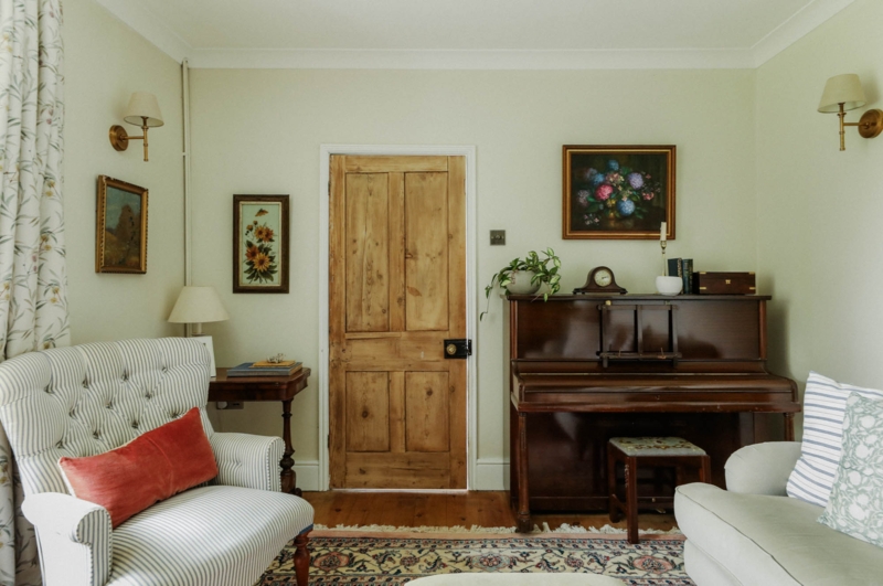 Vintage Upright Wood Piano in a Sage Green English Cottage Living Room