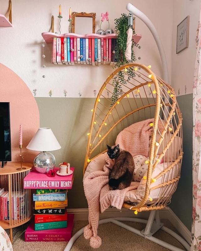 Whimsical Book Nook Design with hanging egg chair and two-tone wall.