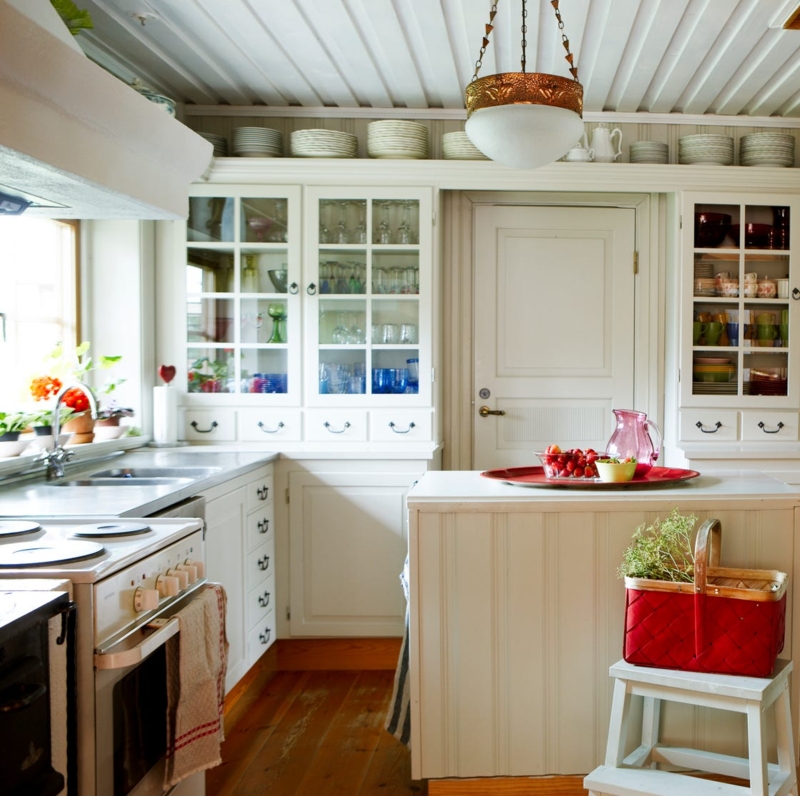White Beadboard Kitchen Island in Vintage Cottage with Colorful Glassware