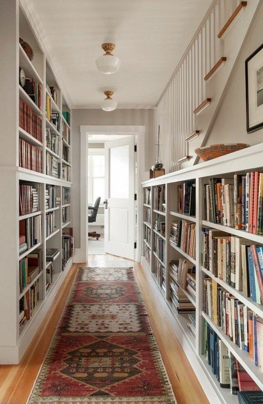 White Built-in Bookshelves with Waist High Ledge and Tribal Runner