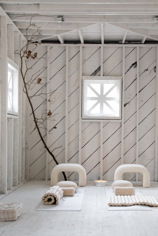 Whitewashed Yoga Studio with Diagonal Wood Cladding and Boucle Stools