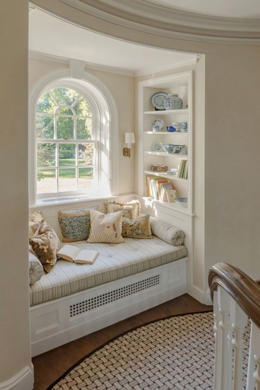 Window Seat Arched Nook, Integrated Bookshelf, Striped Upholstery.