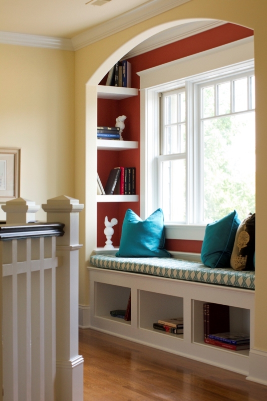Window Seat inside Arched Alcove with Red Accent Wall Reading Corner.