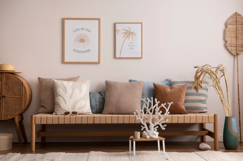Woven Strap Bench with Coral Embroidered Pillow in Coastal Entryway