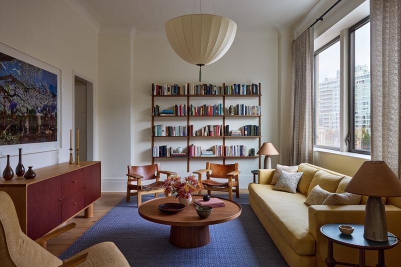 Yellow Sofa Living Room Ideas with Blue Rug and Wall Mounted Bookshelf